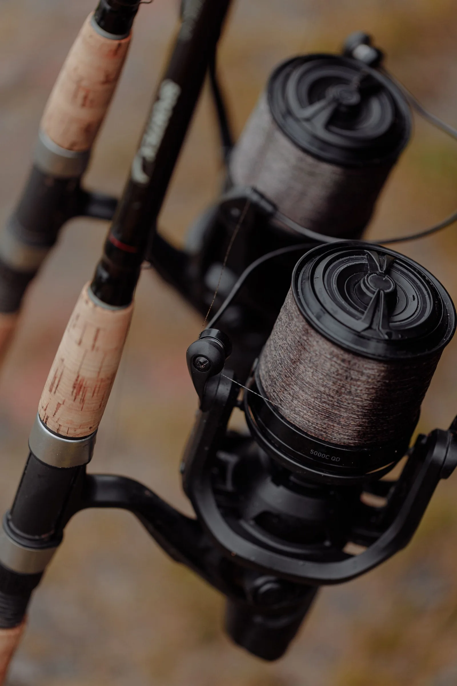 Close view of fishing rods, reels and cork handles.
